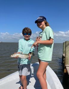A group of 3 people fishing on the Texas coast