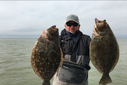 Two summer flounder, each about 22 inches long, caught in TX