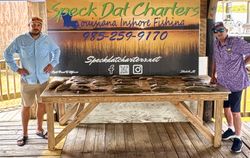 Fishing charter display table with fresh catch from Louisiana inshore fishing trip in Slidell