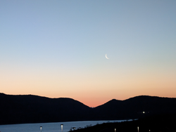 Serene mountain sunset with a catch of the day.