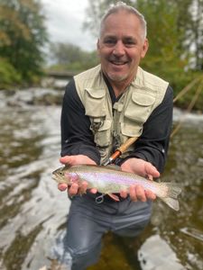 Angler with a rainbow trout fish caught in Arlington