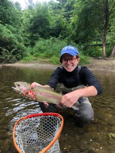 A person fishing in an unknown location