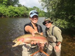 Angler with a large rainbow trout caught in VT