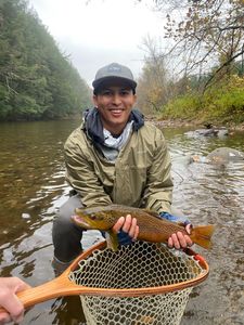 A person fishing in an unknown location