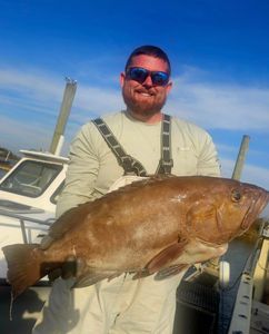 A fisherman holding a 25-inch fish in Sneads Ferry