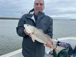 One fisherman catching a fish at Folly Beach