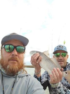 Two people enjoying fishing at Folly Beach