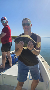 Angler with a southern flounder fish in South Carolina