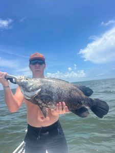 A person fishing in the water at Spanish Fort