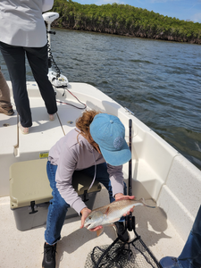 Peaceful day on the water, reeling in a catch.