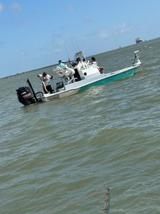 Fishing boat with outboard motor and fishing equipment on water near Port Arthur TX