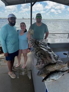 Fishing charter catch of speckled trout and sheepshead displayed on boat deck in Port Arthur TX