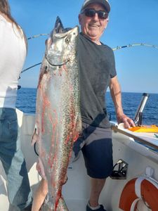 A person fishing in Kenosha with a 31-inch catch