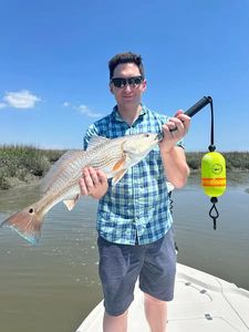 A person holding a fishing rod at Midway