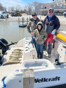 Three anglers with a fish in Ludington