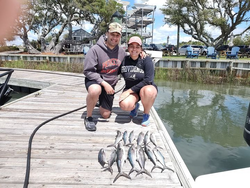 2 anglers reeling in their catch in NC