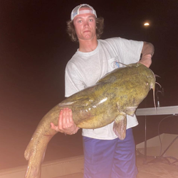 A person fishing at Hummels Wharf with a 24-inch catch