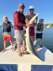 Successful blacktip shark fishing charter at Cedar Point NC with large catch displayed on boat deck