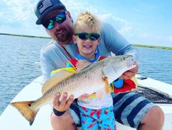 Little anglers prized redfish catch. 