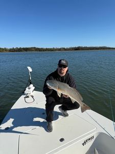 A fisherman holding a large redfish in NC