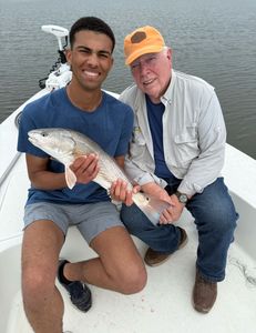 Two people fishing for redfish at Cedar Point