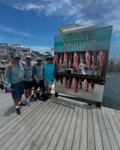 4 people fishing with 2 small fish in FL