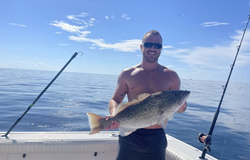 Angler proudly holding a 25-inch gag grouper caught while fishing in Destin