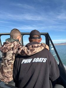 Fishing boat on calm waters near Gold Beach Oregon with anglers viewing the ocean