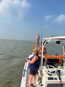 Reeling in the thrill of deep sea jigging under partly cloudy skies!