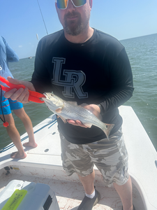 Reeling in a feisty redfish on a deep sea jigging adventure in South Padre Island!