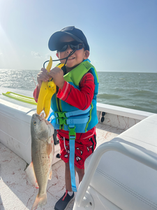 Battling a feisty Redfish in the crystal clear waters of South Padre Island!