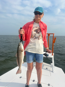 Reeling in an impressive Redfish on the shores of South Padre Island!