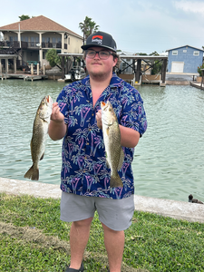 Reeling in a good catch by the serene river.