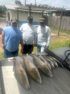 Reeling in a good time by the water.