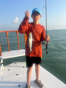 Tight lines with a feisty Spotted Weakfish on the line!