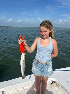Reeling in a tasty spotted weakfish on a breezy South Padre Island day!
