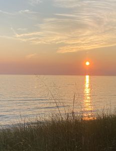 Sunset glows over calm lake.
