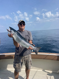A person fishing in Muskegon with a 22-inch catch