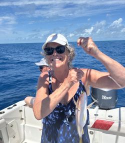 Angler holding caught fish on fishing boat in Little Torch Key FL waters