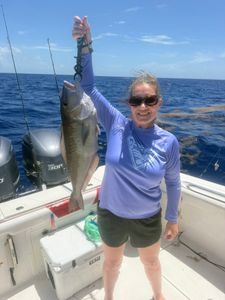 Angler holding freshly caught fish on fishing boat in Little Torch Key FL waters