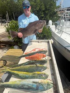 Fishing catch display showing red grouper and mahi mahi from Little Torch Key FL