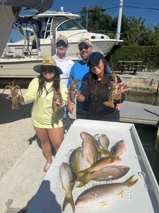 Fresh yellowfin and mixed fish species displayed on dock after successful fishing trip in Little Torch Key FL