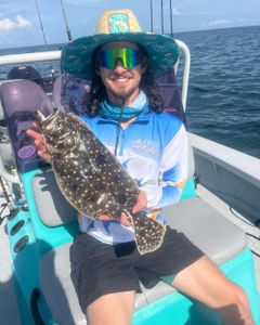A person fishing for a summer flounder in Sarasota