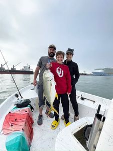 Three people fishing at the docks in Port Canaveral