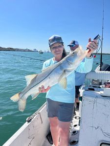 Angler holding caught snook on fishing charter boat in Port Canaveral FL waters