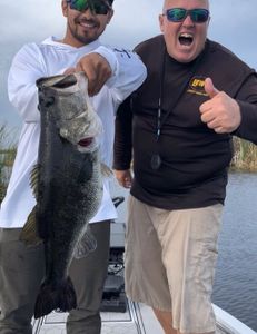 Two anglers holding a large 26-inch fish in FL