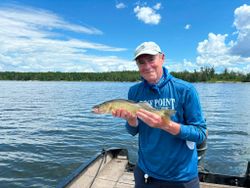 Walleye fishing catch held over lake waters in Nestor Falls ON