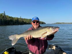 A person fishing for pike-perch in Nestor Falls