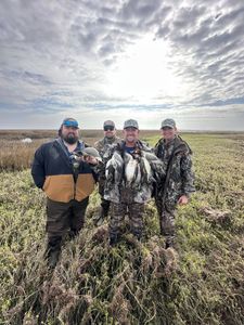 Four people enjoying a fishing and hunting adventure in Matagorda