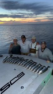 Successful fishing trip in Matagorda TX with catch of fish displayed on boat deck at sunset
